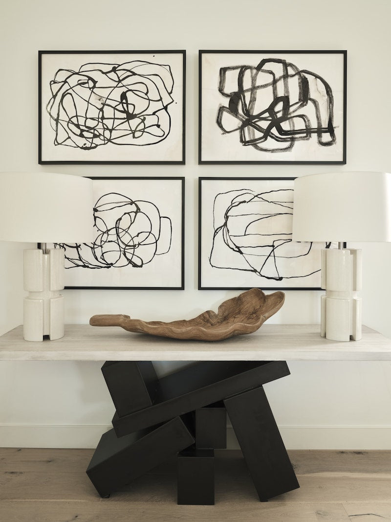 Four Pieces Of Black And White Art Pieces On The Wall