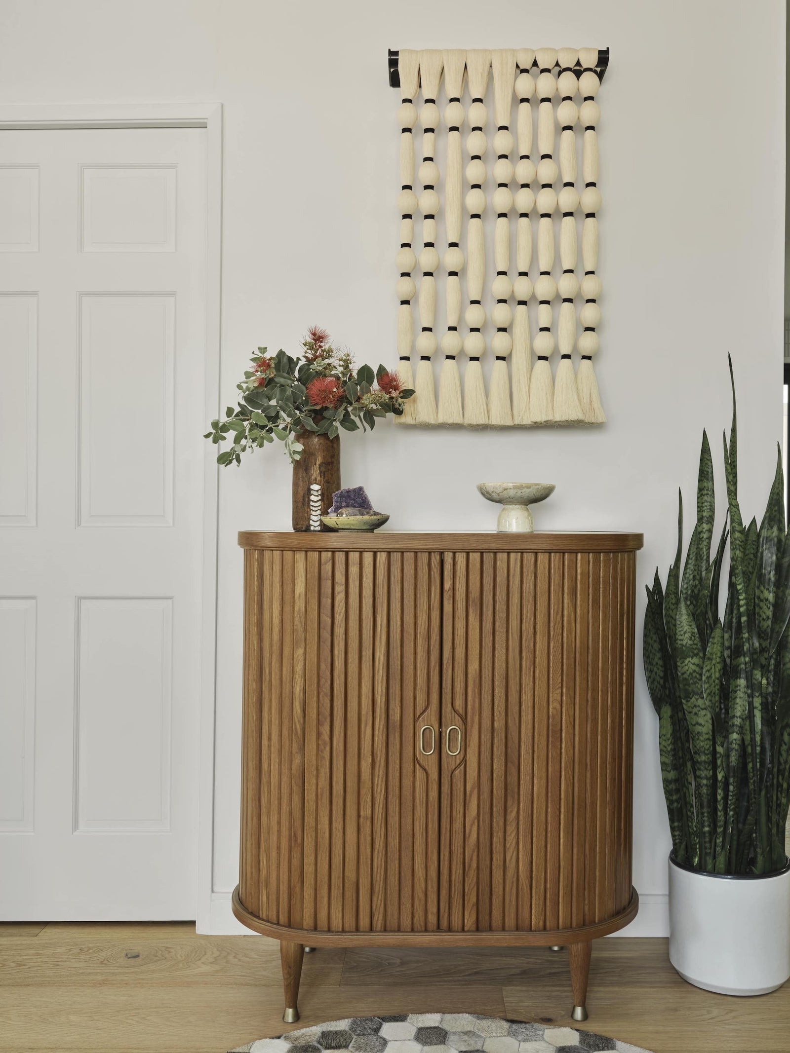 Small Table By The Wall With A Plant On It