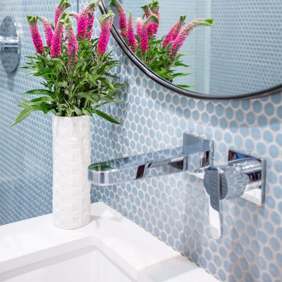 Pink Flowers Next To A Bathroom Sink