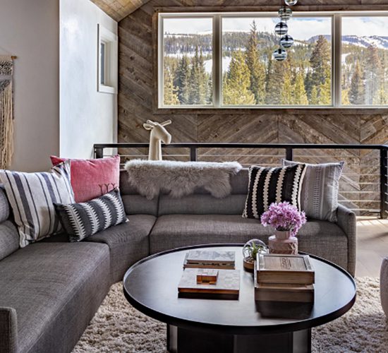 A Wooden Giraffe Head Behind A Couch